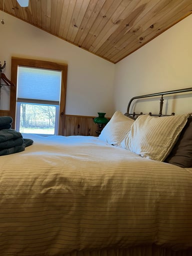 second floor queen bedroom with wall-mounted TV